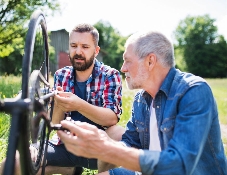 Two people repairing a bicycle.